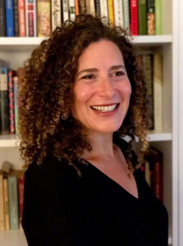 Photo of Lizzie Skurnick in front of a bookshelf